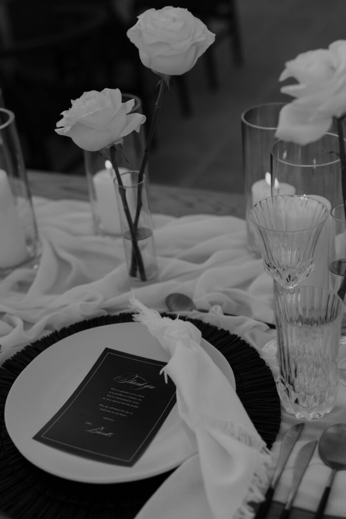 White rose and reception table detail at a black and white Los Cabos wedding