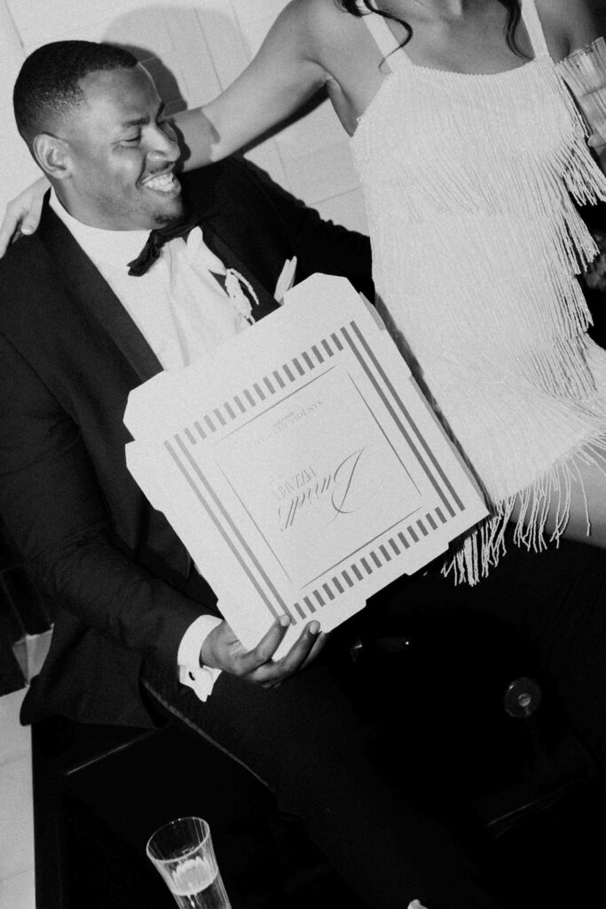 Bride and Groom with their custom pizza boxes at Casa Mariposa Villa wedding reception