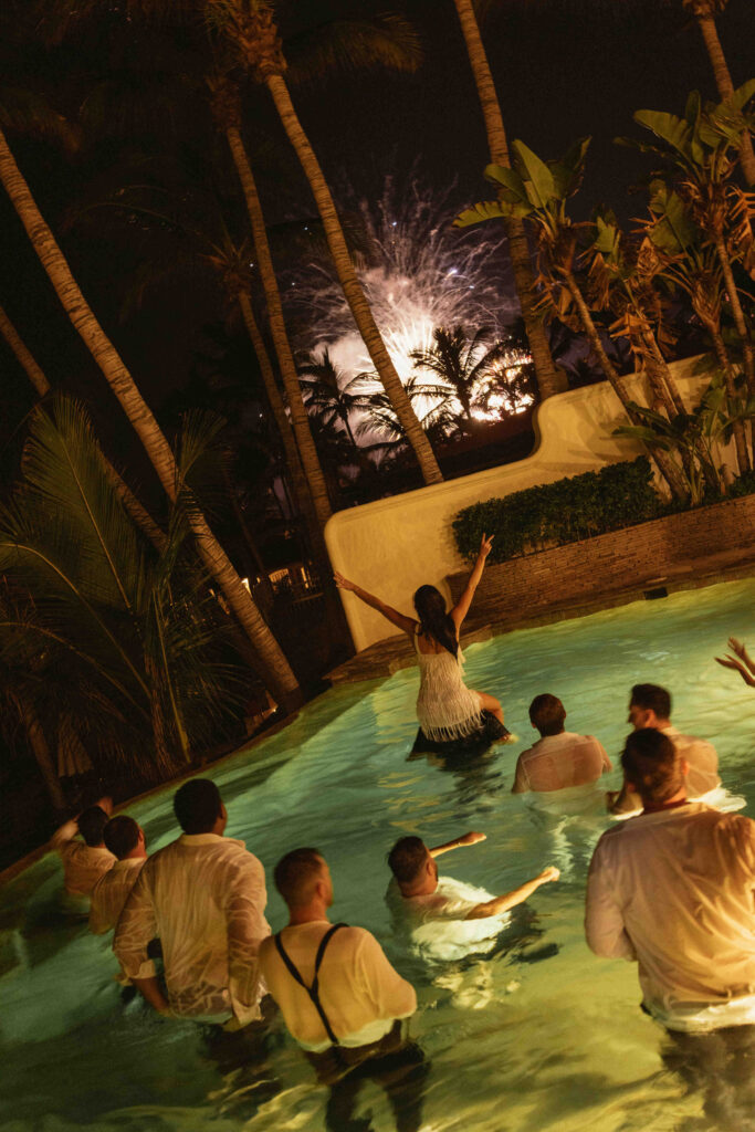 Wedding guests celebrating fireworks by the pool at Casa Mariposa Villa, Los Cabos