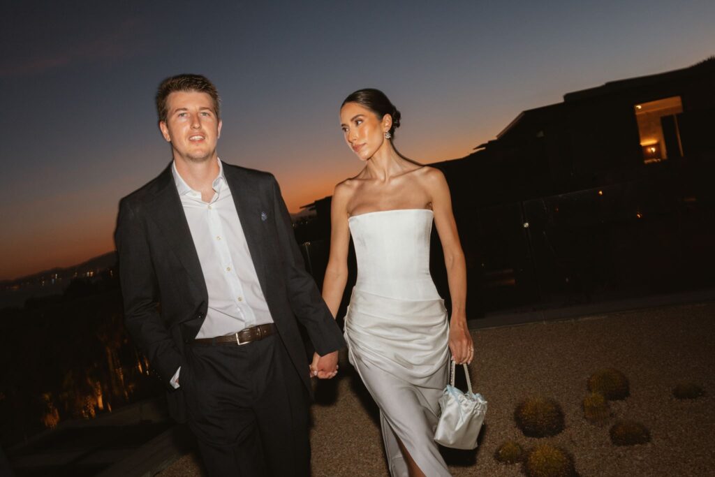 Bride and groom walking together at dusk before their Flora Farms wedding