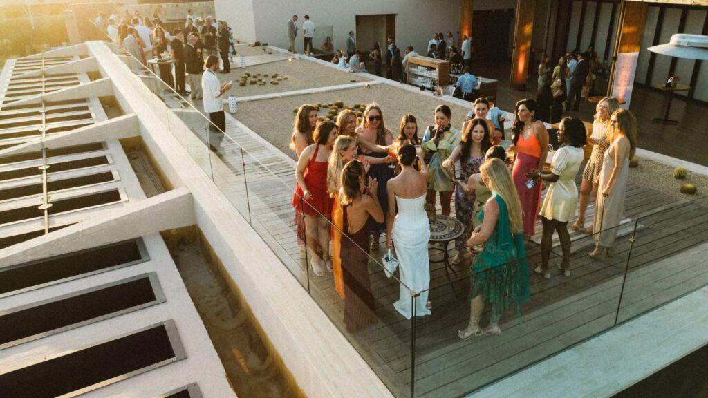 Wedding guests gathered on a balcony at a Los Cabos welcome party