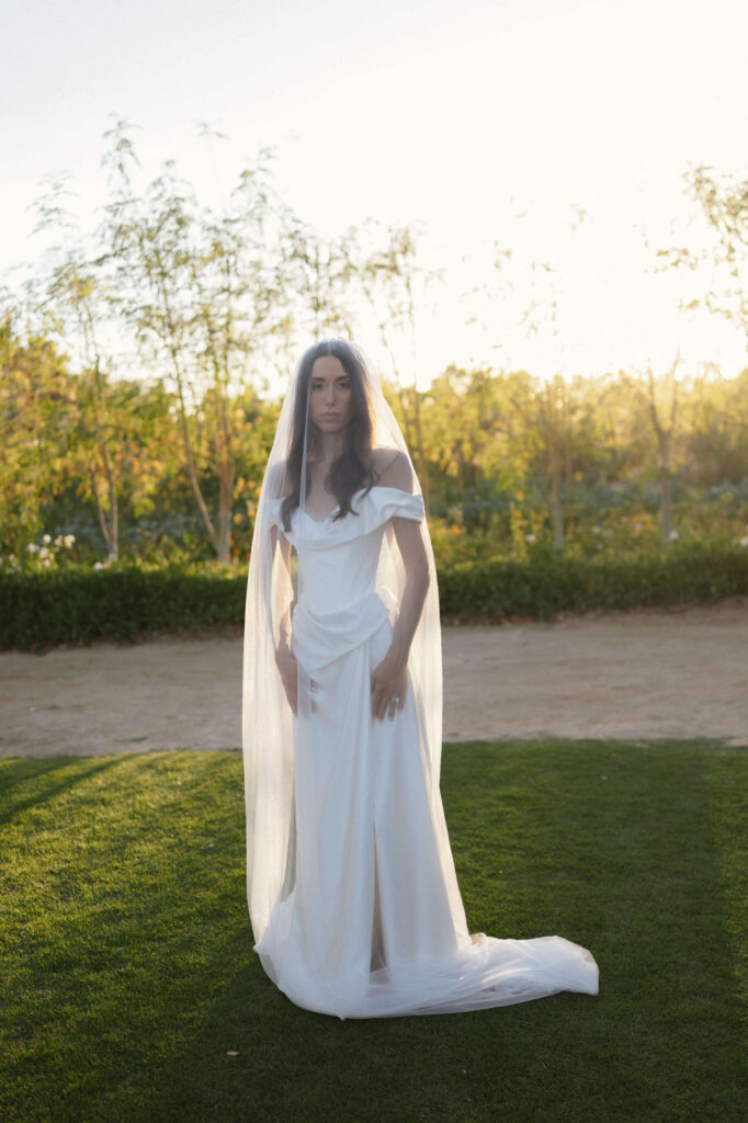 Bride on lawn wearing Vivienne Westwood at Flora Farms Cabos Wedding